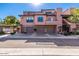 Townhouse with a three-car garage, stone accents, and a stucco facade providing curb appeal at 20660 N 40Th St # 2016, Phoenix, AZ 85050