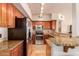 Charming kitchen with stainless steel appliances, wooden cabinetry and granite counters at 20660 N 40Th St # 2016, Phoenix, AZ 85050