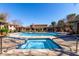 Community pool with hot tub, lounge chairs, and covered cabanas for relaxing poolside at 20660 N 40Th St # 2016, Phoenix, AZ 85050