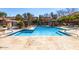 Resort-style community pool with cabanas and lounge chairs offering a relaxing oasis at 20660 N 40Th St # 2016, Phoenix, AZ 85050