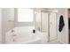 Bright bathroom showcasing a soaking tub and glass-enclosed shower at 2425 E Beverly Rd, Phoenix, AZ 85042