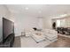Spacious living room with a plush sofa, area rug and adjacent dining area at 2425 E Beverly Rd, Phoenix, AZ 85042