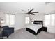 Spacious main bedroom with a modern ceiling fan, large windows, and cozy decor at 2425 E Beverly Rd, Phoenix, AZ 85042
