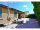 Outdoor patio featuring comfortable lounge chairs, brick pavers, and partial shade for relaxation at 2425 E Beverly Rd, Phoenix, AZ 85042