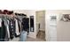 Organized walk-in closet with hanging racks and shelving in the laundry room at 2425 E Beverly Rd, Phoenix, AZ 85042