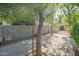 Backyard patio area with mature trees and a block wall fence, offering a private and shaded outdoor space at 2534 N Mitchell St. St, Phoenix, AZ 85006