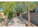 Backyard patio area with mature trees and a storage shed, creating a private and functional outdoor space at 2534 N Mitchell St. St, Phoenix, AZ 85006