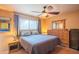 Cozy bedroom with plush bedding, tile floors, and a ceiling fan at 2534 N Mitchell St. St, Phoenix, AZ 85006