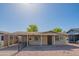 Inviting brick home with a covered front porch, gravel landscaping, and a fenced yard, offering a cozy aesthetic at 2534 N Mitchell St. St, Phoenix, AZ 85006