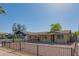 Quaint brick home featuring a secure metal fence, offering both charm and privacy to the property's facade at 2534 N Mitchell St. St, Phoenix, AZ 85006