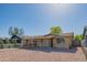 Welcoming single-story brick home with gravel landscaping and a stylish black metal fence, enhancing curb appeal at 2534 N Mitchell St. St, Phoenix, AZ 85006