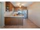 Bright kitchen with wooden cabinets, stainless steel appliances, and tile flooring perfect for culinary enthusiasts at 2534 N Mitchell St. St, Phoenix, AZ 85006