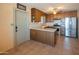 Well-lit kitchen featuring stainless steel appliances, wooden cabinets, and tile flooring for a modern cooking space at 2534 N Mitchell St. St, Phoenix, AZ 85006