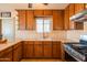 Traditional kitchen featuring wood cabinets, tile floors, and stone countertops at 2534 N Mitchell St. St, Phoenix, AZ 85006