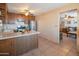 Functional kitchen showcasing tile floors, wooden cabinets, and a view into the adjacent living area at 2534 N Mitchell St. St, Phoenix, AZ 85006