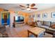 Comfortable living room with a ceiling fan, tile flooring, and a large entertainment center for modern living at 2534 N Mitchell St. St, Phoenix, AZ 85006