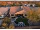 Aerial view of backyard, fire pit, outdoor kitchen, and desert landscaping at 30224 N 52Nd Pl, Cave Creek, AZ 85331