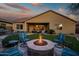 Backyard patio with desert landscaping, fire pit, and built-in seating area at 30224 N 52Nd Pl, Cave Creek, AZ 85331