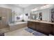 Luxurious bathroom with a soaking tub, walk-in shower, double vanity, and tiled floors at 30224 N 52Nd Pl, Cave Creek, AZ 85331