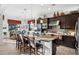 Spacious kitchen with dark wood cabinets, a large island with seating, and stainless steel appliances at 30224 N 52Nd Pl, Cave Creek, AZ 85331