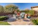 Outdoor entertaining space with built-in grill, kitchen, and dining furniture at 30224 N 52Nd Pl, Cave Creek, AZ 85331
