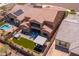 A landscaped backyard featuring a lawn, hot tub, fire pit, and outdoor kitchen, providing relaxation and entertainment at 30876 N 128Th Dr, Peoria, AZ 85383