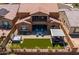 Stunning aerial view of a backyard with a hot tub, firepit, and lounge area at 30876 N 128Th Dr, Peoria, AZ 85383