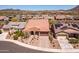 An aerial shot of a landscaped house featuring a tile roof, desert landscaping, and a two-car garage at 30876 N 128Th Dr, Peoria, AZ 85383