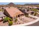 An aerial shot of a landscaped house featuring a tile roof, desert landscaping, and a two-car garage at 30876 N 128Th Dr, Peoria, AZ 85383