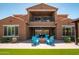 Backyard with fire pit and Adirondack chairs, set against a two-story home at 30876 N 128Th Dr, Peoria, AZ 85383