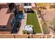 A backyard featuring a lawn, hot tub, fire pit, and outdoor kitchen, providing relaxation and entertainment at 30876 N 128Th Dr, Peoria, AZ 85383