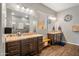 Beautiful bathroom showcasing dual vanities with granite countertops, tiled shower, and wood-look floors at 30876 N 128Th Dr, Peoria, AZ 85383