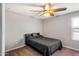 Cozy bedroom featuring a ceiling fan and window with blinds providing natural light at 30876 N 128Th Dr, Peoria, AZ 85383