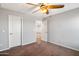 Bedroom with neutral walls and carpet, two white doors, and a ceiling fan at 30876 N 128Th Dr, Peoria, AZ 85383