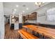 Open floor plan featuring kitchen and dining room with rustic table at 30876 N 128Th Dr, Peoria, AZ 85383