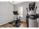 Bright exercise room with tile floors and modern workout equipment at 30876 N 128Th Dr, Peoria, AZ 85383