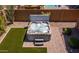 Inviting hot tub in a well-manicured backyard with pavers and green turf at 30876 N 128Th Dr, Peoria, AZ 85383