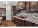 Modern kitchen featuring built-in stainless appliances, granite countertops, and lots of cabinet storage at 30876 N 128Th Dr, Peoria, AZ 85383