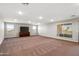 Spacious living room with carpeted floors, recessed lighting, and a TV on an entertainment center at 30876 N 128Th Dr, Peoria, AZ 85383