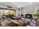 Spacious living room with comfortable seating, fireplace, and backyard access at 30876 N 128Th Dr, Peoria, AZ 85383