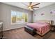Inviting primary bedroom with large windows and a ceiling fan at 30876 N 128Th Dr, Peoria, AZ 85383