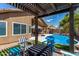 Inviting backyard patio area with a pergola, comfortable seating, a waterfall feature and a refreshing pool at 3793 E Lexington Ave, Gilbert, AZ 85234