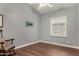 Comfortable bedroom with light gray walls, wood floors, and natural lighting at 3793 E Lexington Ave, Gilbert, AZ 85234