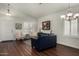 Bright living room with hardwood floors, plantation shutters, stylish furnishings, and neutral paint at 3793 E Lexington Ave, Gilbert, AZ 85234