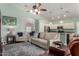 Bright living room with wood floors, comfortable seating, and view into the kitchen at 3793 E Lexington Ave, Gilbert, AZ 85234