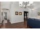 Bright living room with hardwood floors, neutral paint, and elegant chandeliers at 3793 E Lexington Ave, Gilbert, AZ 85234
