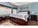 Spacious main bedroom with wood-look floors, picture frame molding, and large windows at 3793 E Lexington Ave, Gilbert, AZ 85234