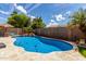 Sparkling pool with a rock waterfall feature in the backyard is perfect for relaxation and recreation at 3793 E Lexington Ave, Gilbert, AZ 85234