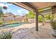 Charming backyard with a sparkling pool, beautiful stone patio, and covered pergola, perfect for outdoor living at 3854 E Cathedral Rock Dr, Phoenix, AZ 85044