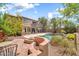 Spacious backyard featuring a pool, patio, lush landscaping, and an outdoor fireplace, ideal for entertaining at 3854 E Cathedral Rock Dr, Phoenix, AZ 85044